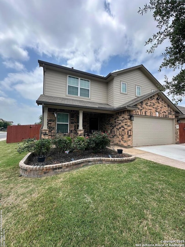 traditional home with fence, concrete driveway, a front yard, and brick siding