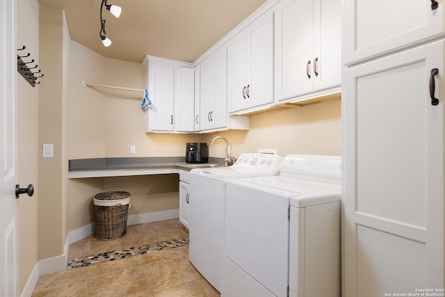 137A Spanish Pass, Boerne, TX 78006 - laundry room with washing machine and dryer, cabinet space, light tile patterned floors, and baseboards