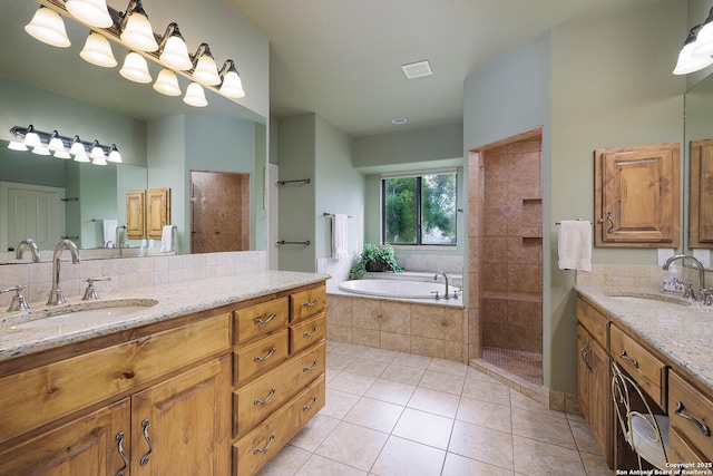 137A Spanish Pass, Boerne, TX 78006 - bathroom featuring a tile shower, a garden tub, tile patterned flooring, and two vanities