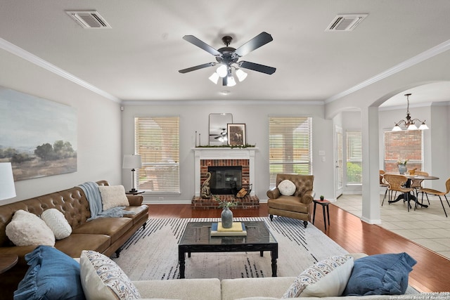 8715 Anton Chico, Helotes, TX 78023 - living area featuring arched walkways, visible vents, and ornamental molding