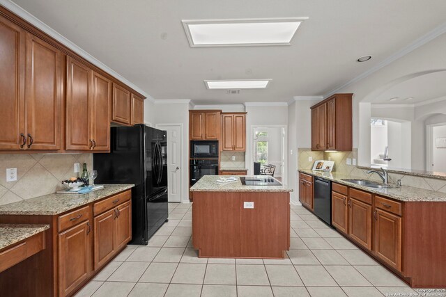 8715 Anton Chico, Helotes, TX 78023 - kitchen featuring light tile patterned floors, a sink, black appliances, and a center island