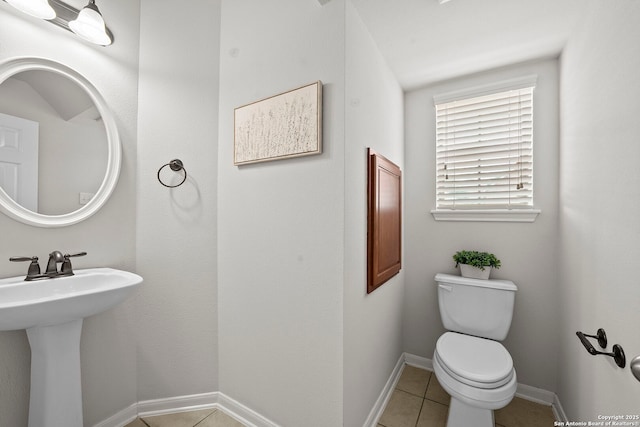 8715 Anton Chico, Helotes, TX 78023 - half bath with a sink, baseboards, tile patterned flooring, and toilet