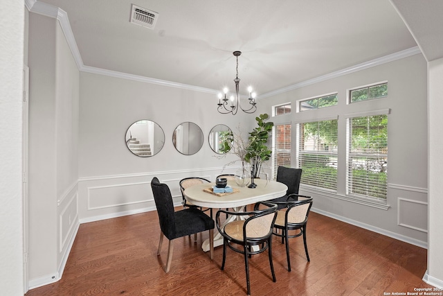 8715 Anton Chico, Helotes, TX 78023 - dining area with dark wood-style flooring, a notable chandelier, visible vents, and ornamental molding