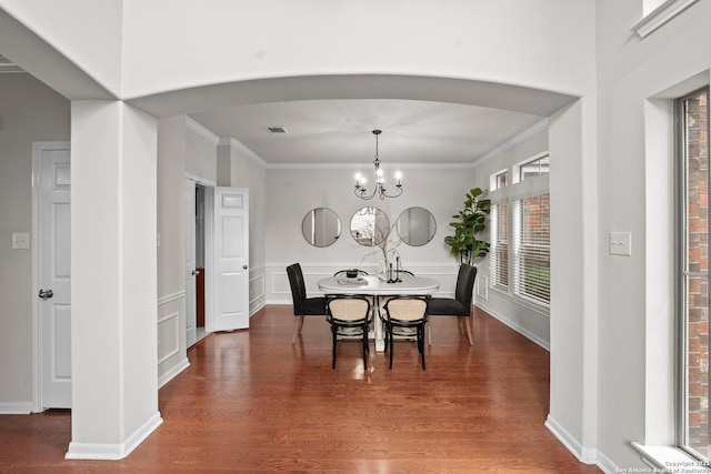 8715 Anton Chico, Helotes, TX 78023 - dining room with visible vents, arched walkways, wood finished floors, a chandelier, and ornamental molding