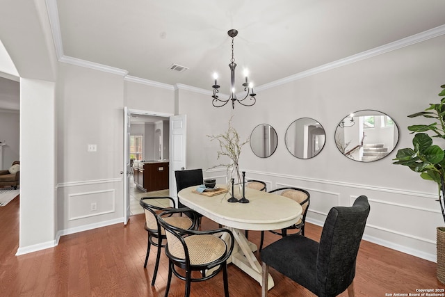 8715 Anton Chico, Helotes, TX 78023 - dining space with an inviting chandelier, ornamental molding, wood finished floors, and visible vents