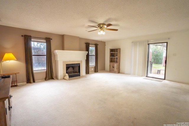 1903 Copperfield, San Antonio, TX 78251 - unfurnished living room featuring carpet floors, a ceiling fan, a fireplace with flush hearth, and a textured ceiling