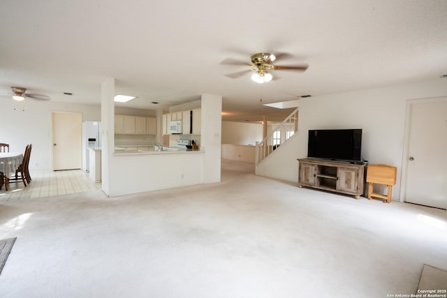 1903 Copperfield, San Antonio, TX 78251 - unfurnished living room featuring a ceiling fan, light carpet, and stairway
