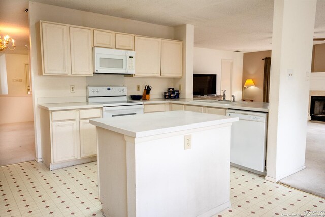 1903 Copperfield, San Antonio, TX 78251 - kitchen featuring a kitchen island, a sink, light countertops, light floors, and white appliances