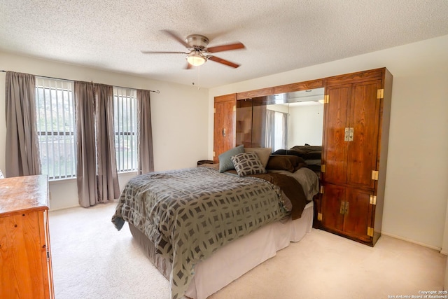1903 Copperfield, San Antonio, TX 78251 - bedroom featuring light colored carpet, a ceiling fan, and a textured ceiling
