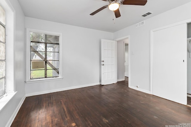 unfurnished bedroom featuring visible vents, a ceiling fan, baseboards, and hardwood / wood-style flooring