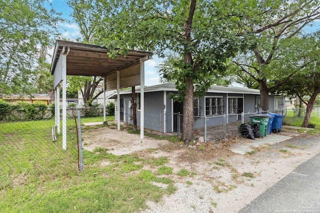 view of property exterior with fence and a lawn