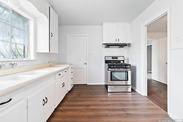 kitchen with stainless steel gas stove, extractor fan, light countertops, white cabinetry, and a sink
