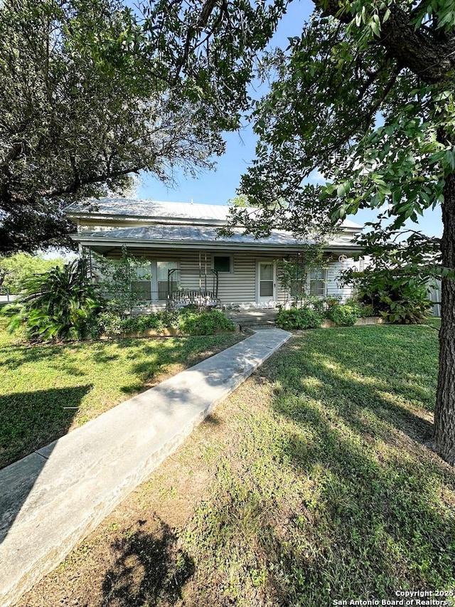 view of front of home with a porch and a front lawn