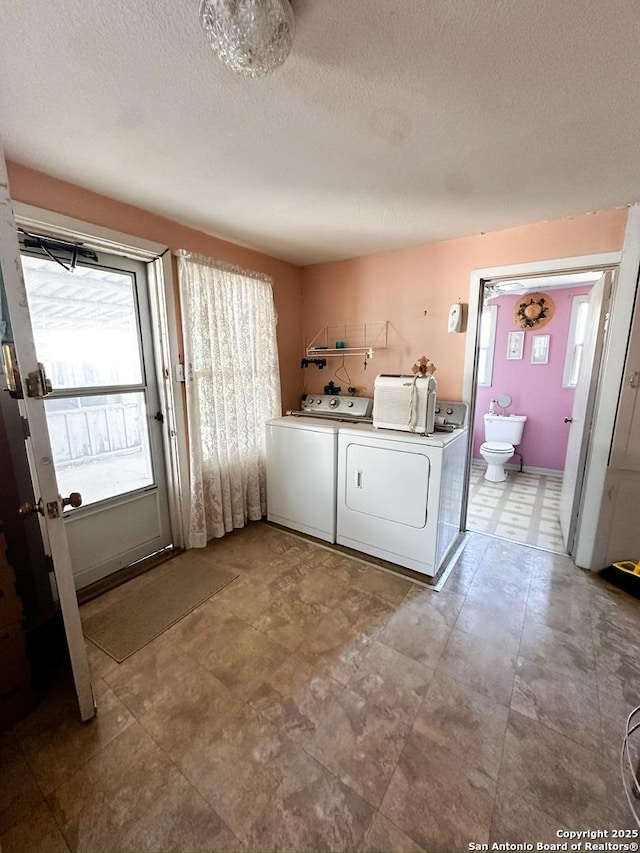 laundry room with a textured ceiling, laundry area, and independent washer and dryer
