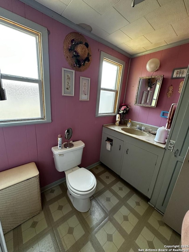 bathroom featuring vanity, tile patterned floors, and toilet
