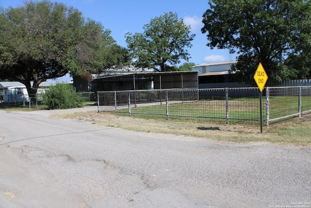 exterior space with fence and a front lawn