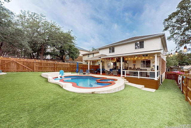 view of pool with a yard, a jacuzzi, a fenced in pool, and a fenced backyard