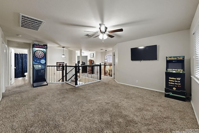 interior space with visible vents, a ceiling fan, and baseboards