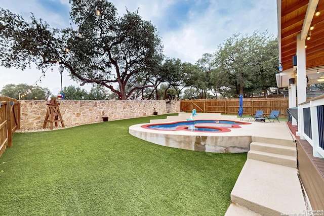 view of yard with a patio, an in ground hot tub, and a fenced backyard