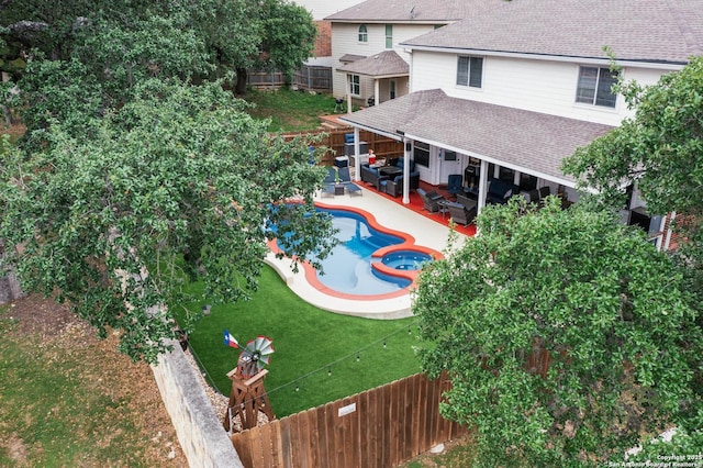 view of swimming pool with a fenced backyard, a pool with connected hot tub, a patio area, and outdoor lounge area
