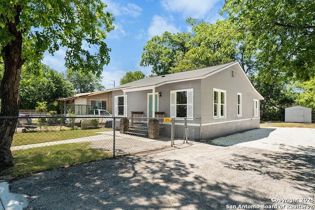 view of front of property featuring an outdoor structure, a shed, and fence private yard