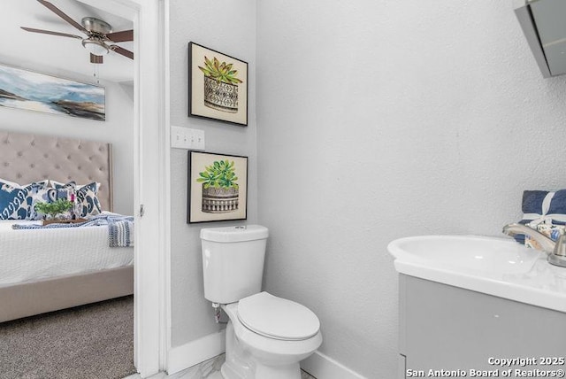 ensuite bathroom featuring marble finish floor, toilet, baseboards, connected bathroom, and a ceiling fan