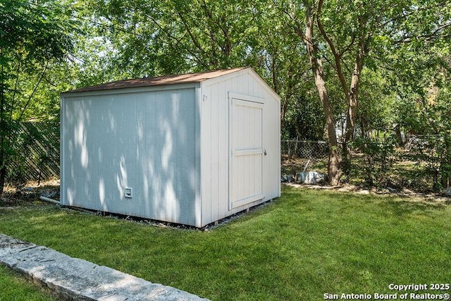 view of shed with fence