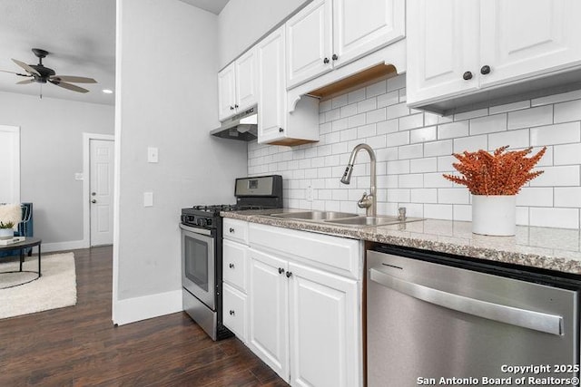 kitchen with ceiling fan, a sink, under cabinet range hood, stainless steel appliances, and dark wood-type flooring