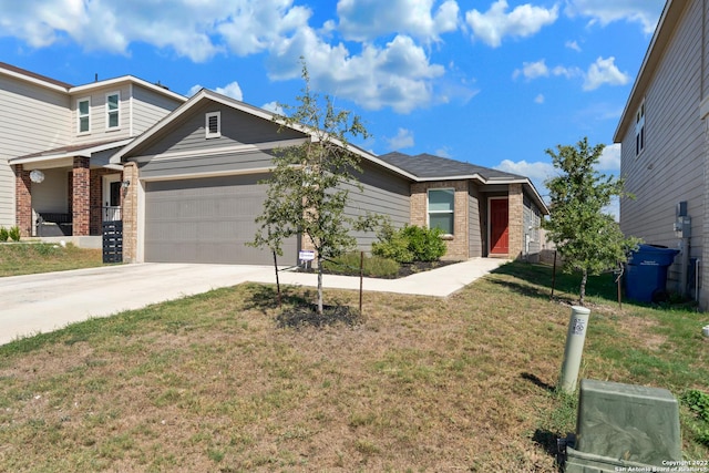 view of front of home featuring concrete driveway, brick siding, a front yard, and a garage