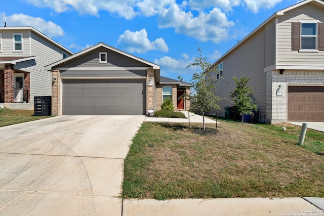 view of front of property featuring brick siding, a garage, driveway, and a front yard