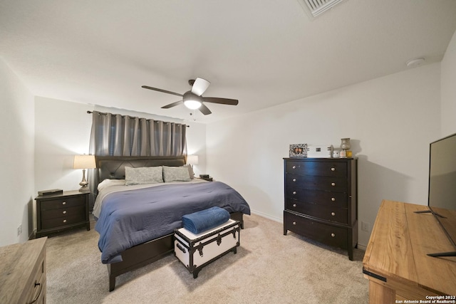 bedroom with a ceiling fan, light colored carpet, and visible vents