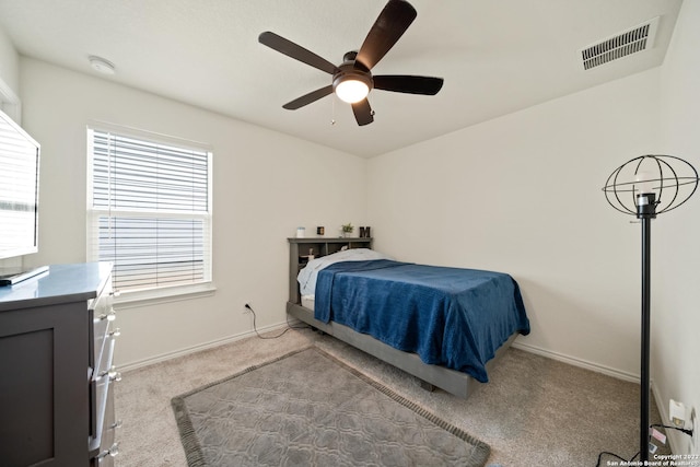 carpeted bedroom featuring visible vents, a ceiling fan, baseboards, and multiple windows
