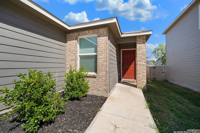 view of exterior entry with fence