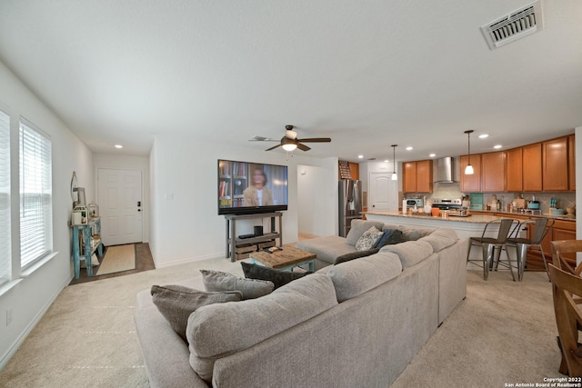living room with light colored carpet, a ceiling fan, visible vents, and recessed lighting