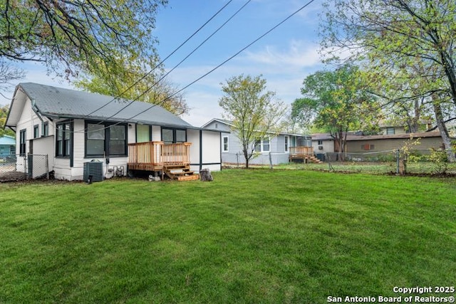 back of house with fence, central air condition unit, a lawn, and a wooden deck