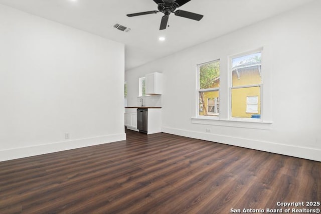 unfurnished living room with visible vents, recessed lighting, dark wood finished floors, and baseboards