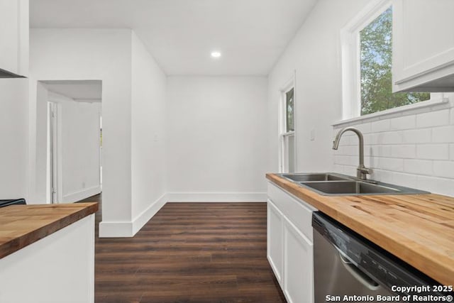 kitchen featuring a sink, white cabinetry, tasteful backsplash, stainless steel dishwasher, and butcher block counters