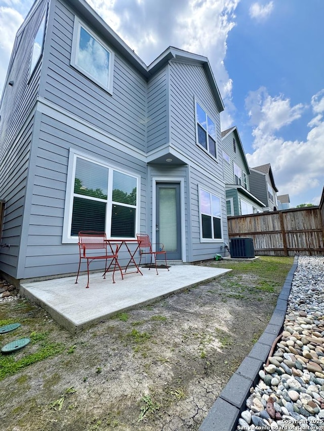 back of house featuring central air condition unit, fence, and a patio area