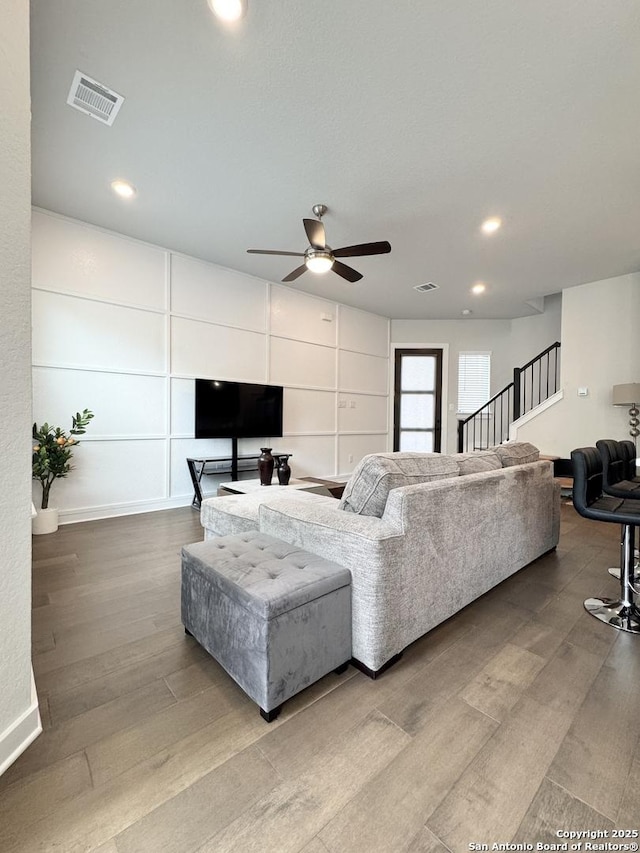 living room featuring ceiling fan, recessed lighting, wood finished floors, and visible vents