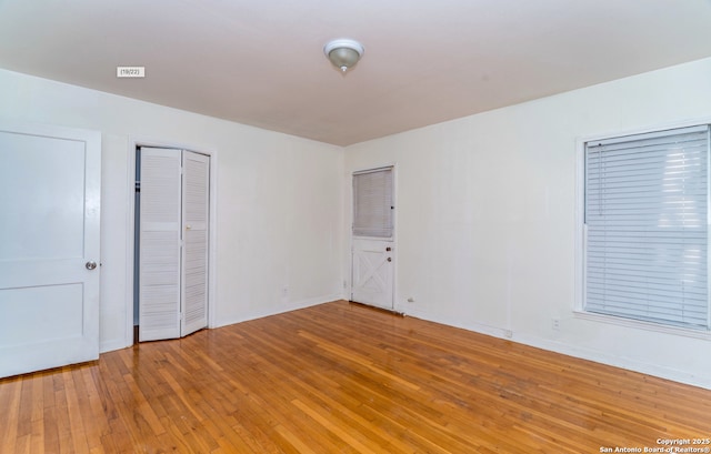 unfurnished bedroom featuring light wood-style floors and baseboards