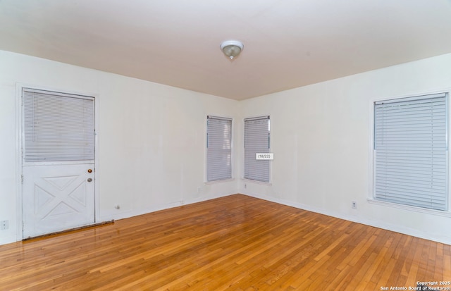 unfurnished room with light wood-style floors and baseboards