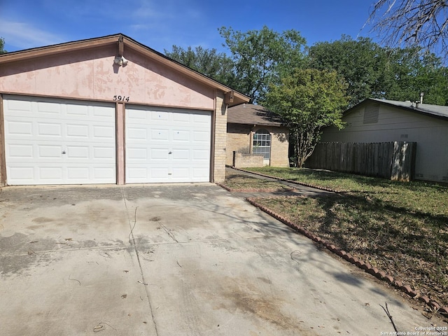 exterior space featuring concrete driveway and fence