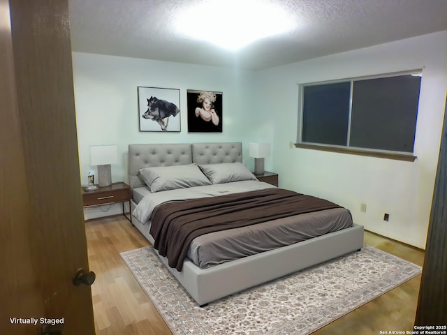 bedroom featuring wood finished floors