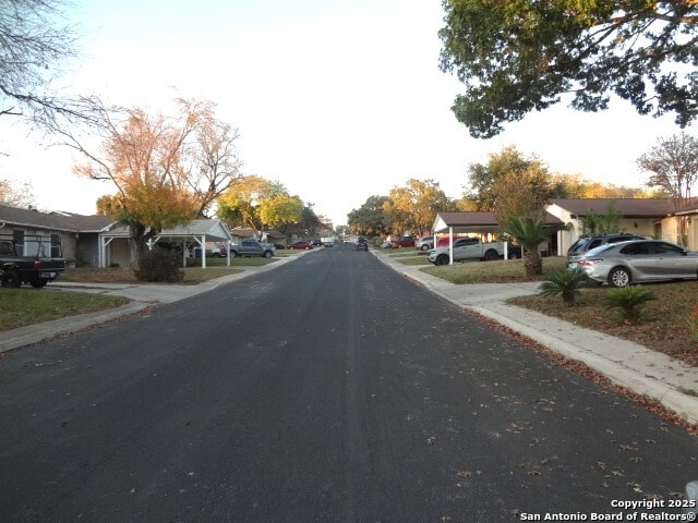 view of street with a residential view and curbs