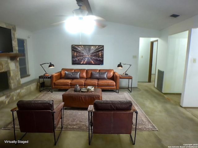 carpeted living area with ceiling fan, a fireplace, and visible vents