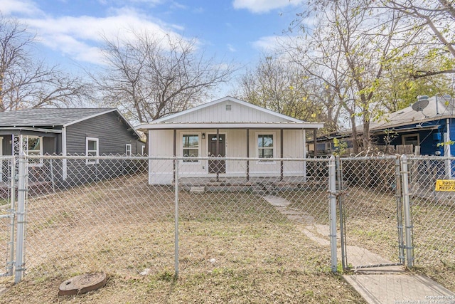 bungalow-style home with a gate, a fenced front yard, and a porch