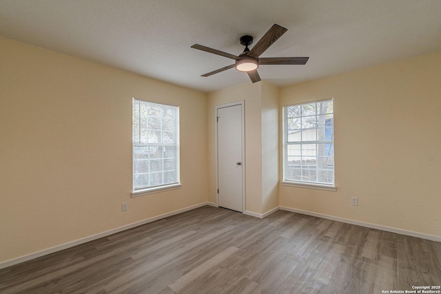 unfurnished bedroom with baseboards, ceiling fan, and wood finished floors
