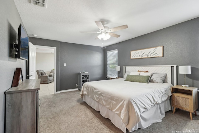 carpeted bedroom with ceiling fan and visible vents