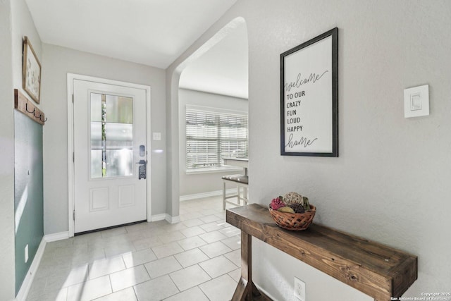 entrance foyer featuring light tile patterned flooring and baseboards