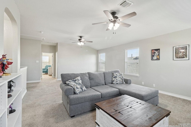 living area with baseboards, ceiling fan, visible vents, and light colored carpet